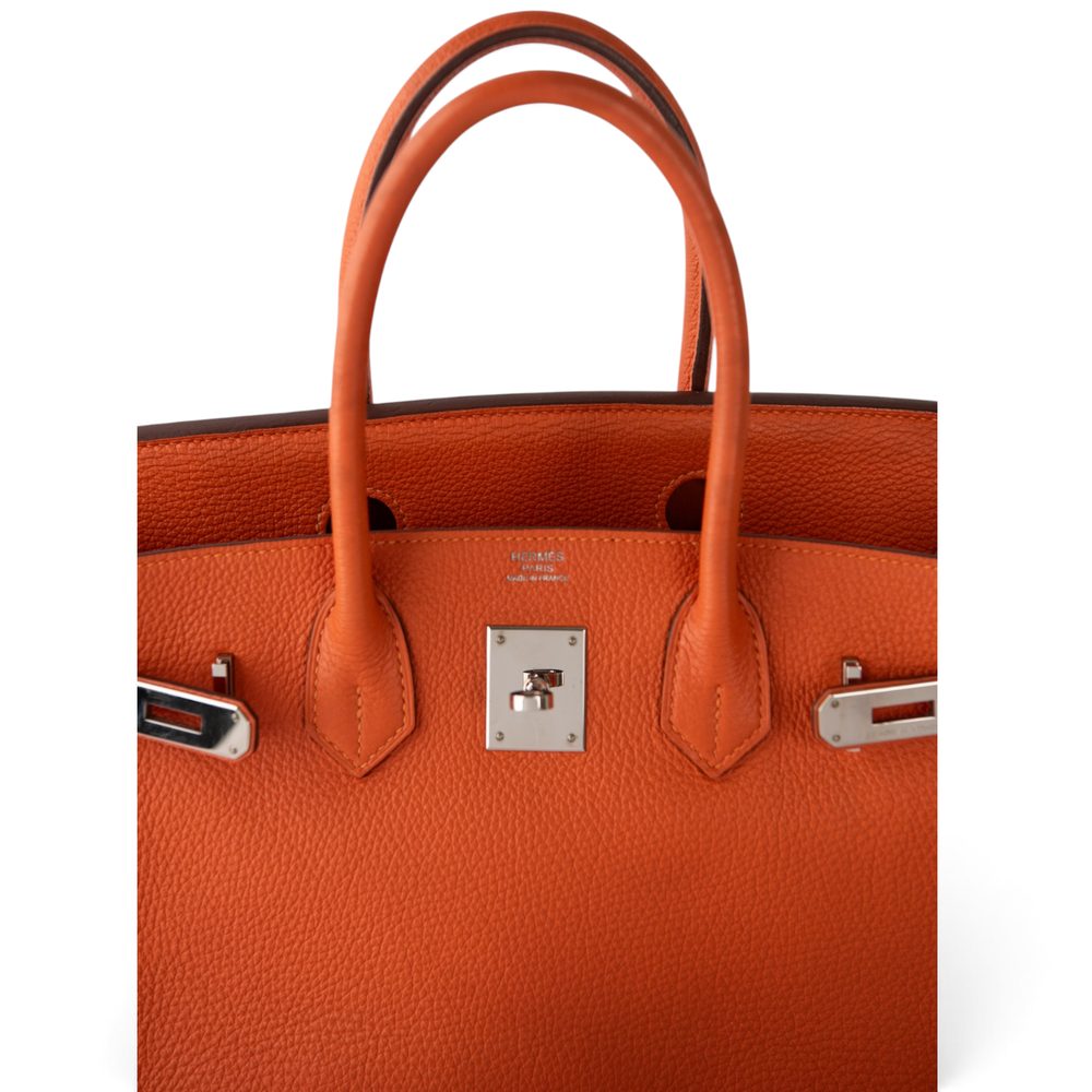 Close detail of the Hermès stamp and palladium turn-lock